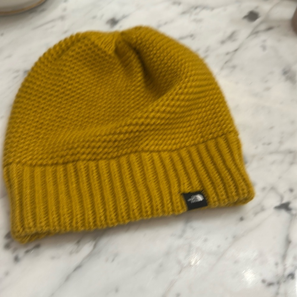 Knitted cap The North Face gold never worn